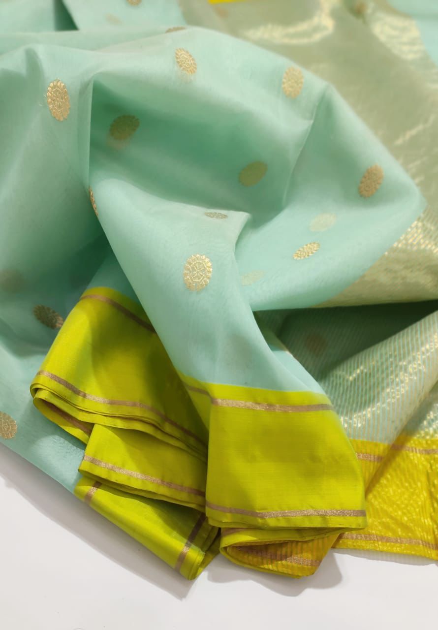 Turquoise Blue-green Chanderi Saree with bright green border and floral motifs