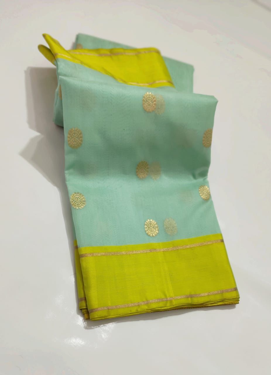 Turquoise Blue-green Chanderi Saree with bright green border and floral motifs